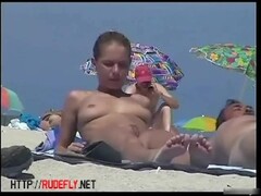 Nude beach spy camera with a sexy couple in focus Thumb